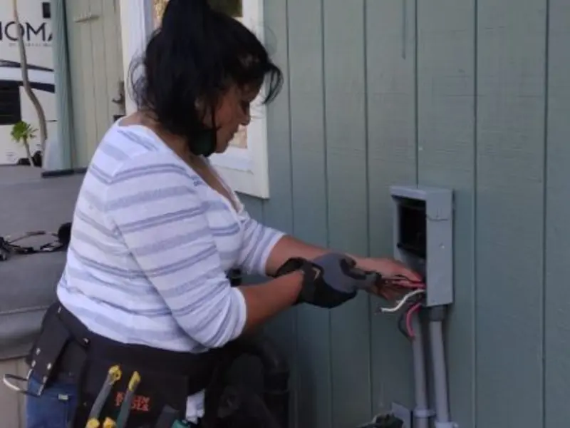 Licensed electrician wiring an exterior subpanel in Dardanelle